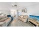 Comfortable living room featuring tile floors, ceiling fan, and plenty of seating at 13632 Clara Ln, Port Charlotte, FL 33981