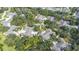 Aerial view showcases a residential neighborhood with mature trees and well-maintained homes at 1420 Winding Oak Dr, Port Charlotte, FL 33948