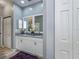 Bathroom featuring double vanity with marble countertops and linen closet at 1420 Winding Oak Dr, Port Charlotte, FL 33948