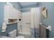 Bright bathroom with white tile shower and white vanity cabinet for storage at 1420 Winding Oak Dr, Port Charlotte, FL 33948