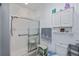 Bathroom featuring glass enclosed shower, toilet and overhead storage at 1420 Winding Oak Dr, Port Charlotte, FL 33948