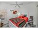 Cozy bedroom with ceiling fan, and large bed featuring colorful bedding at 1420 Winding Oak Dr, Port Charlotte, FL 33948