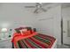 Bedroom featuring ceiling fan, ensuite bathroom and double door closet at 1420 Winding Oak Dr, Port Charlotte, FL 33948