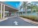 Exterior view of the clubhouse featuring a covered entrance, lush plants, and vibrant colors at 1420 Winding Oak Dr, Port Charlotte, FL 33948
