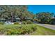 Attractive community entrance featuring landscaping, decorative signage, and an American flag at 1420 Winding Oak Dr, Port Charlotte, FL 33948
