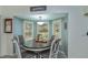 Cozy breakfast nook features natural light, modern lighting fixture, and a round wood table at 1420 Winding Oak Dr, Port Charlotte, FL 33948