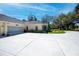 Spacious driveway and garage of a well-kept yellow home with lush surroundings at 1420 Winding Oak Dr, Port Charlotte, FL 33948