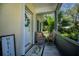 Inviting screened front porch with seating, welcome decor, and tiled floor at 1420 Winding Oak Dr, Port Charlotte, FL 33948