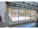 Screened garage door offering an open view of the driveway and lush front yard at 1420 Winding Oak Dr, Port Charlotte, FL 33948