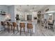 Open kitchen with white cabinets, stainless steel appliances, and a marble countertop island with bar stools at 1420 Winding Oak Dr, Port Charlotte, FL 33948