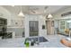 Bright kitchen featuring white cabinets, stainless steel appliances, and dining area in the background at 1420 Winding Oak Dr, Port Charlotte, FL 33948