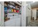 Organized laundry closet features storage shelves and side-by-side washer and dryer at 1420 Winding Oak Dr, Port Charlotte, FL 33948