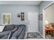Cozy living room featuring a gray sofa, wood-look flooring, and stylish decor at 1420 Winding Oak Dr, Port Charlotte, FL 33948