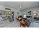 Open living room featuring a gray sofa, ceiling fan, tile flooring, and access to a sunroom at 1420 Winding Oak Dr, Port Charlotte, FL 33948