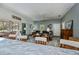 Bright living room with gray walls, ceiling fan, sliding doors to the patio, and wood-look flooring at 1420 Winding Oak Dr, Port Charlotte, FL 33948
