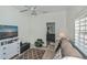 Comfortable living room with leather sofa, entertainment center, and access to another room at 1420 Winding Oak Dr, Port Charlotte, FL 33948