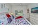 Comfortable bedroom featuring a large window, ceiling fan, white furniture and bright accents at 1420 Winding Oak Dr, Port Charlotte, FL 33948