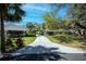 Scenic view of well-manicured properties in a lush, tree-filled neighborhood at 1420 Winding Oak Dr, Port Charlotte, FL 33948