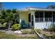 Cozy patio area with a yellow painted wall and a turquoise lounge chair at 1420 Winding Oak Dr, Port Charlotte, FL 33948