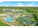 Aerial view showcasing the community's pool, tennis courts, and surrounding landscape at 14234 Heritage Landing Blvd # 1016, Punta Gorda, FL 33955