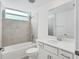 Bright bathroom with tile floors, tiled shower, and vanity at 14234 Heritage Landing Blvd # 1016, Punta Gorda, FL 33955