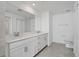 Bright bathroom features double sinks, white cabinets, tile floors, and a large mirror at 14234 Heritage Landing Blvd # 1016, Punta Gorda, FL 33955