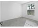 Bright bedroom with neutral walls, tiled floors, and a window with palm tree views at 14234 Heritage Landing Blvd # 1016, Punta Gorda, FL 33955