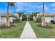 Beautiful condo with lush landscaping, manicured lawn, and walkway leading to the front entrance at 14234 Heritage Landing Blvd # 1016, Punta Gorda, FL 33955