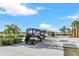 Convenient golf cart parking area next to a golf course and a beautiful blue sky at 14234 Heritage Landing Blvd # 1016, Punta Gorda, FL 33955