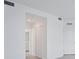 Hallway with access to a bathroom, featuring neutral paint and tile flooring at 14234 Heritage Landing Blvd # 1016, Punta Gorda, FL 33955