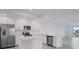 Modern, all-white kitchen featuring stainless steel appliances and a center island at 14234 Heritage Landing Blvd # 1016, Punta Gorda, FL 33955