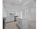 Modern white kitchen boasts a central island, stainless steel appliances, and sleek countertops at 14234 Heritage Landing Blvd # 1016, Punta Gorda, FL 33955