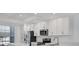 Modern white kitchen features stainless steel appliances and abundant cabinet space at 14234 Heritage Landing Blvd # 1016, Punta Gorda, FL 33955