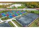 Aerial view of pickleball and tennis courts amid lush landscaping, showcasing the community's recreational facilities at 14234 Heritage Landing Blvd # 1016, Punta Gorda, FL 33955