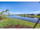 Scenic water view with lush landscaping and neighboring homes in a tranquil community setting under clear blue skies at 14234 Heritage Landing Blvd # 1016, Punta Gorda, FL 33955
