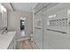 Modern bathroom featuring a glass-enclosed shower, tiled accent wall, and a light neutral palette at 155 Francis Ne Dr, Port Charlotte, FL 33952