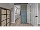 Charming bathroom view featuring a unique multi-colored sliding barn door and hardwood flooring at 155 Francis Ne Dr, Port Charlotte, FL 33952