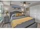 Stylish bedroom featuring a ceiling fan, hardwood floors, and a closet for ample storage space at 155 Francis Ne Dr, Port Charlotte, FL 33952