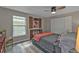 Sunlit bedroom with hardwood floors, closet space, and a cozy daybed creating an inviting retreat at 155 Francis Ne Dr, Port Charlotte, FL 33952