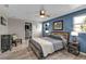 Well-lit bedroom with a modern bed frame, stylish blue accent wall, and a spacious closet at 155 Francis Ne Dr, Port Charlotte, FL 33952