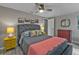 Comfortable bedroom featuring a ceiling fan, gray walls, and colorful accents creating a calm space at 155 Francis Ne Dr, Port Charlotte, FL 33952