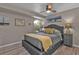 Bright bedroom featuring a ceiling fan, gray walls, and hardwood floors creating a calm and inviting atmosphere at 155 Francis Ne Dr, Port Charlotte, FL 33952