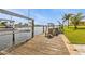 Well-maintained wooden dock with a boat lift, offering easy access to the water and picturesque waterfront views at 155 Francis Ne Dr, Port Charlotte, FL 33952