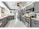 Well-lit kitchen with gray cabinets, stainless appliances, and ample counter space at 155 Francis Ne Dr, Port Charlotte, FL 33952