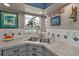 Bright kitchen with stainless sink and countertops with water view at 155 Francis Ne Dr, Port Charlotte, FL 33952