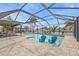 Inviting screened-in pool area with lounge seating and dining space, perfect for entertaining and relaxation at 155 Francis Ne Dr, Port Charlotte, FL 33952