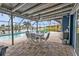Charming covered patio with dining table and view of the pool, ideal for outdoor entertaining and dining at 155 Francis Ne Dr, Port Charlotte, FL 33952