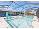 Relaxing screened-in pool with comfortable lounge chairs, dining area, and ample space for outdoor activities at 155 Francis Ne Dr, Port Charlotte, FL 33952