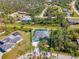 Aerial view showing the house and the area surrounding the home, including many trees and green space at 1563 Arundel Ave, North Port, FL 34288