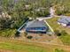 Aerial view showcasing a home with screened-in pool, fully fenced backyard, and tropical landscaping at 1563 Arundel Ave, North Port, FL 34288